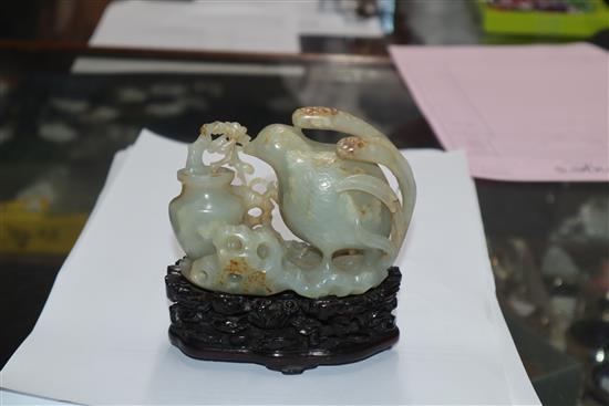 A Chinese pale celadon and russet jade quail carving, wood stand 10cm high including stand